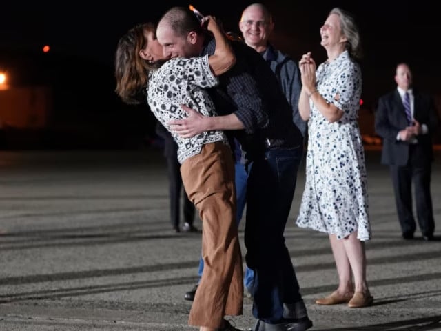 u s journalist evan gershkovic who was released from detention in russia is embraced by his mother ella milman upon his arrival at joint base andrews in maryland us august 1 2024 photo reuters